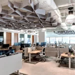 Johnson Lambert's collaborative workspace with modern ceiling design, adjustable desks, and panoramic views - Cornerstone buildout